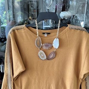 Stone necklace. Gold chains. Not sure what is the exact material used for stones